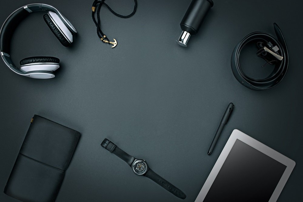 Workplace of business. Modern male accessories and laptop on the black background